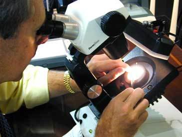 A lab scientist tests the integrity of a gem.